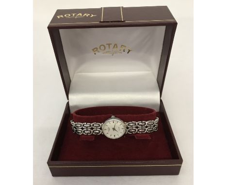 A boxed ladies Rotary wristwatch with sterling silver bracelet strap. White face with silver hour markers, hours and minutes 