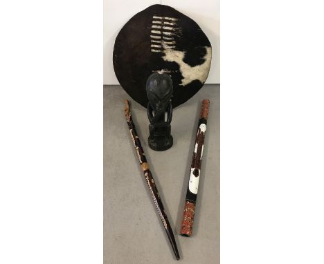 A small collection of 4 ethnographic items. Comprising a Jamaican hand carved wooden walking stick with floral &amp; animal d