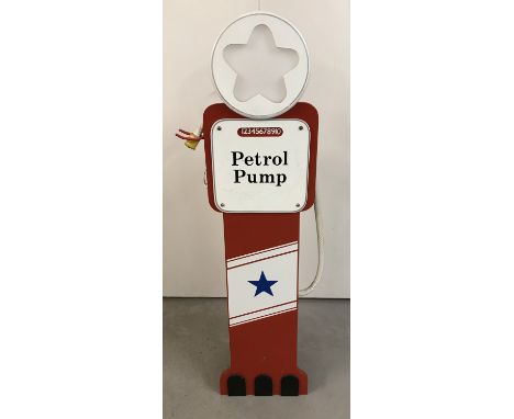 A children's red painted wooden set of shelves in the shape of a Petrol pump with built in light.  Approx 118cm tall.