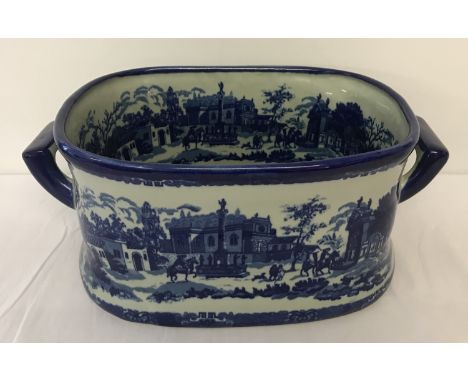 An oval blue &amp; white ceramic pot/footbath. With handles and internal and external decoration.  Approx. W50 x D30 x H20cm.