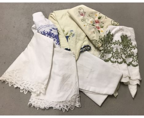 A collection of 8 vintage and modern tablecloths. Some with embroidered or lace detail.  