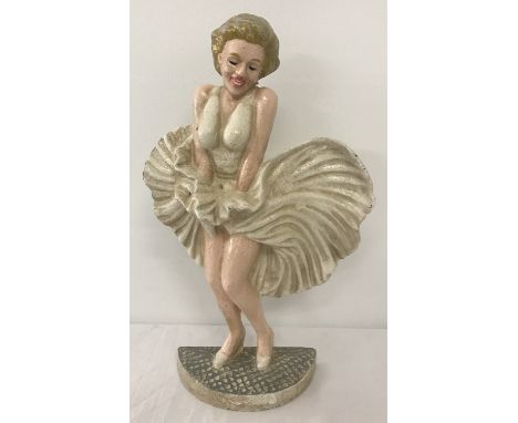 A painted cast iron door stop in the shape of Marilyn Monroe.  Approx. 34cm tall.