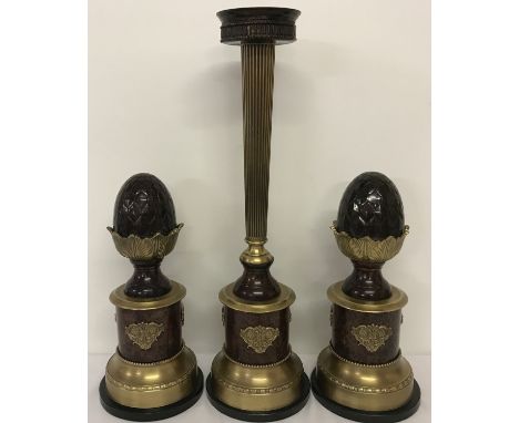 A 3 piece vintage metal candle stand garniture on marble bases, with acorn detail. Candle stand has gilt decoration and colum