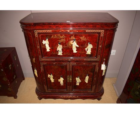 A modern Asian lacquered drinks cabinet, the hinged top opening to reveal glass holders, fall-flap to front, cupboard doors e