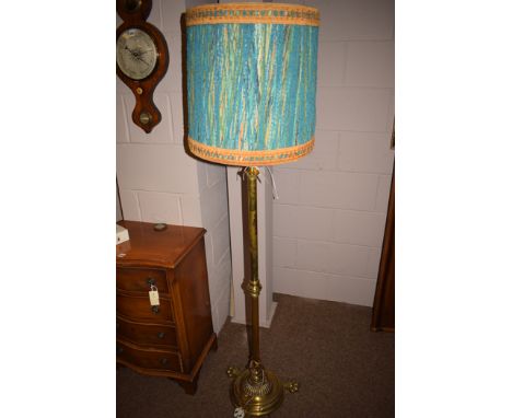 An early 20th Century brass standard lamp, with modern shade (converted to an oil lamp).
