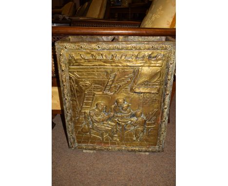 An early 20th Century embossed brass and wood stick stand, depicting a family around a table, original liner to interior.