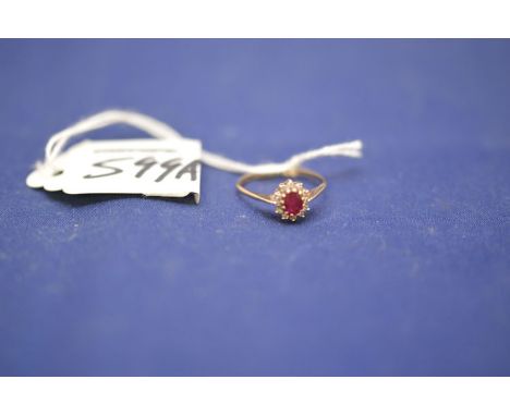 A ruby and diamond cluster ring, the oval facet cut ruby surrounded by brilliant cut diamonds on 9ct. yellow gold shank, ring