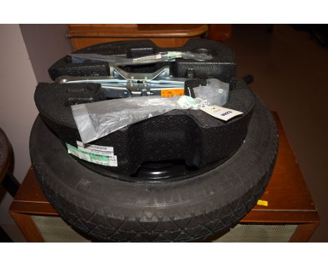 A Continental spare wheel for a Nissan 'Note', inflate to 420kpa 60 PSI, T 125/70 R 15; together with a jack and tools (as ne