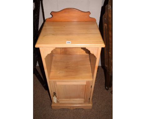 An early 20th Century satin walnut bedside cupboard a single shelf above cupboard door (replaced gallery), 76cms high.