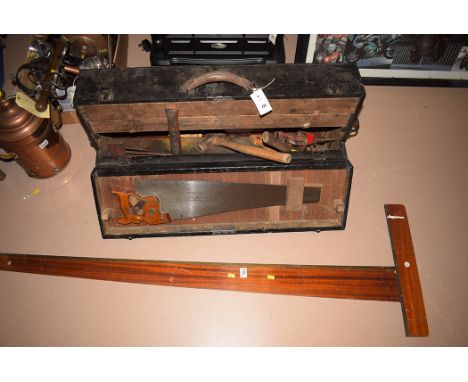 An early 20th Century black painted wooden tool box, containing tools; a mahogany rule by Windsor & Newton; and a saw by Henr