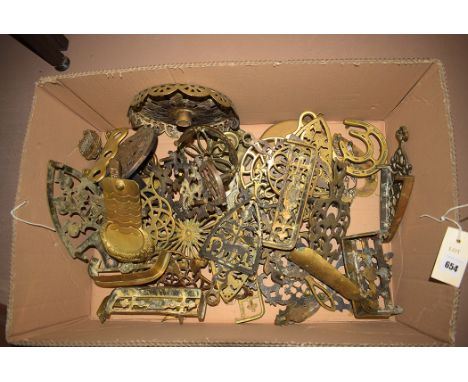 A quantity  of 19th Century and later brass trivets, various designs; a pipe rack; an epaulette; and other items.