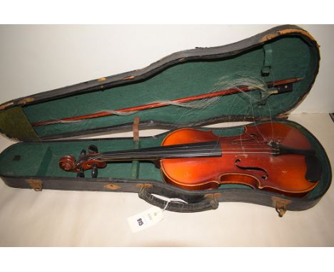 An early 20th Century violin, label to interior reading 'Copy of Antonio Stradivarius, made in Czechoslovakia'; a bow; in fit