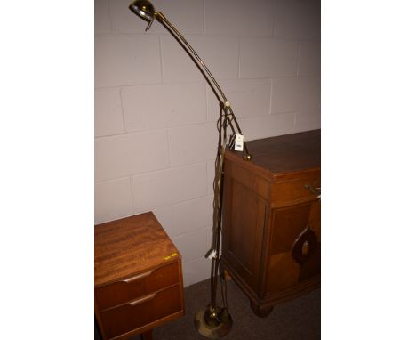 A modern brass floor standing angle poise reading lamp.