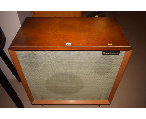 A Heathkit speaker system in stained wood cabinet, raised on legs.