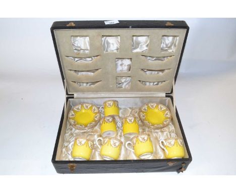 A cased Royal Worcester coffee set, the yellow ground with floral decoration comprising four cups and saucers, three coffee c