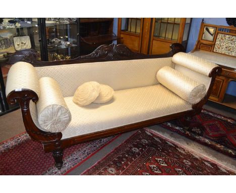 A large late regency mahogany framed sofa with scrolled ends and bolster cushions supported on fluted legs, 210cm wide