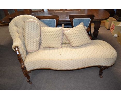 A Victorian walnet framed chaise longue with button upholstered back, serpentine front and scrolled legs, upholstered in a pa