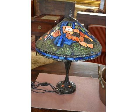 A reproduction Tiffany style table lamp with floral decorated shade, 62cm high