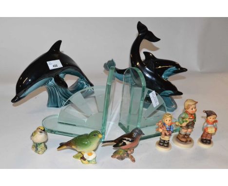 A pair of glass Art Deco style book ends, two Poole pottery models of dolphins and a quantity of three Hummel figures and thr