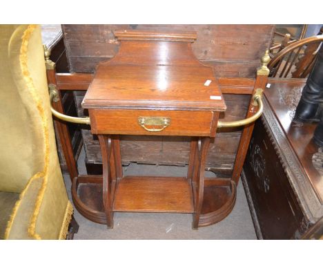 A late Victorian oak and brass mounted stick stand with central drawer, 100cm wide