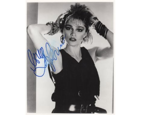 MADONNA: (1958-     ) American Singer & Actress. Signed 8 x 10 photograph of the singer in a half length pose with her arms r