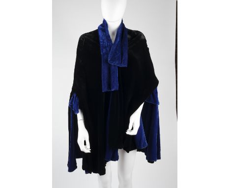 A 1920s royal blue and black velvet lined cape with open front, opening to sleeves with velvet bow detail, with Modele Molyne