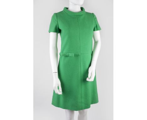 A group of three dresses, the first a 1960s style green round neck collared dress with short sleeves and bow detail to waist.