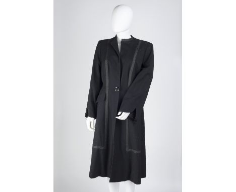 A lady's black coat, with black ribbon trim, full length sleevs, button fastening and pockets to front, Boyd Cooper Ltd, 12 B