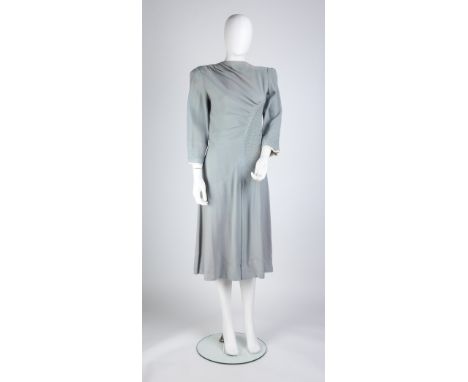 A mid-1940s pale blue crepe dress, with asymmetric curved beaded detail, bracelet length sleeves with ivory trim, button deta