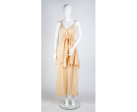 A 1960s peach crepe negligee theatrical costume worn by Judi Dench, with waist sash and orange trimmed straps and v-shaped ne