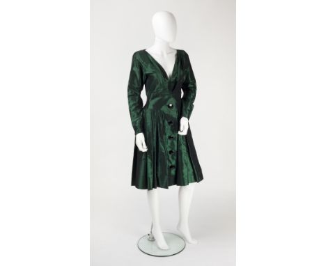 A 1950s style Yves Saint Laurent green satin dress, with deep v-shaped neckline, pleated skirt with faceted button detail and