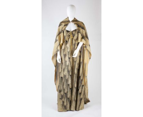A full length gold and black lame dress and cloak from the 1980 film Flash Gordon worn by the character 'Hawkwoman', with fea