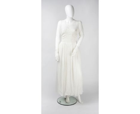 A wedding dress, of floral embroidered design, with ruched bodice and full length sleeves, the circular neck with button fast