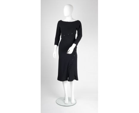 An Alexander McQueen black evening dress, with asymmetric floral button detail to waist and skirt, boat-shaped neck, bracelet