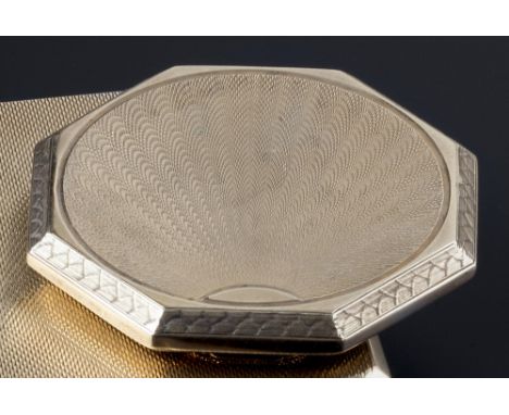 A 9ct gold compact, of hinged octagonal form with engine-turned decoration, hallmarked for London 1938, (mirror deficient), l