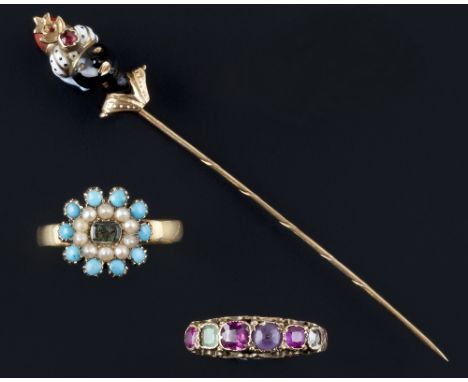 An enamel and gem set stick pin and two vari gem-set rings, the stick pin modelled as a blackamoor, with monochrome enamel tu