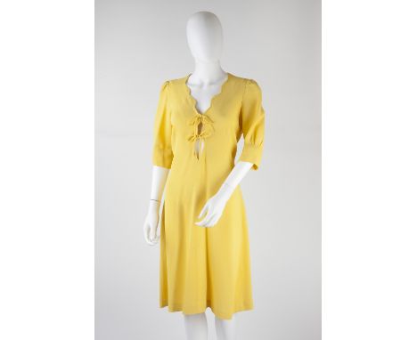 An Ossie Clark for Radley yellow crepe shift dress with short sleeves, scalloped v-shaped neckline with tie fastenings, zip f
