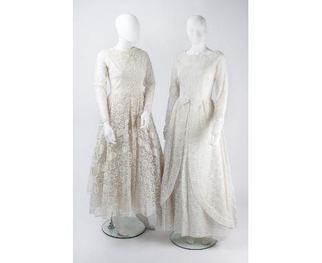 Two late 1950s cream lace wedding dresses, the first with satin ribbon detail to skirt and neckline, full length sleeves, the