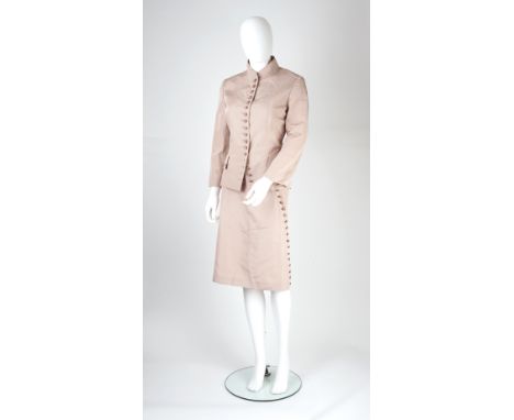 An Alexander McQueen pale pink skirt suit, the jacket with funnel neck, curved button detail to front, pleated back and brace
