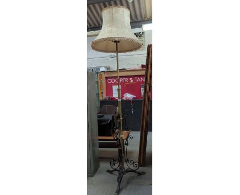 A wrought iron and brass standard lamp with copper floral embellishments 