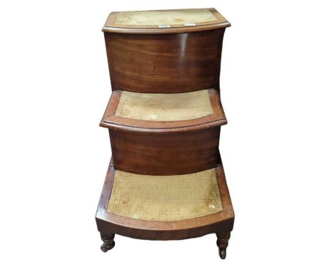 A Victorian mahogany set of bed steps, each step covered in velvet, the top hinging open and the middle step fitted with comm