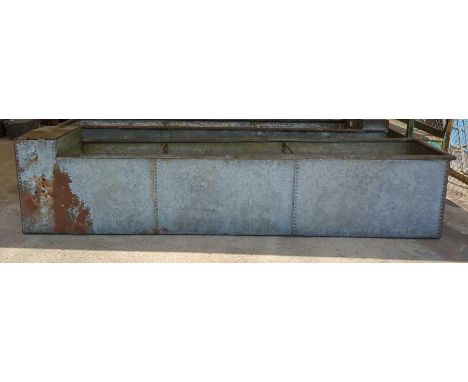 A very large galvanised and rivetted water trough 303cm x 64cm x 63cm deep
