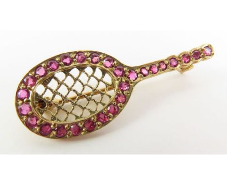 A 9ct gold ruby set brooch in the form of a tennis racquet, 3.5cm long, cased