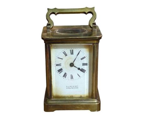 A brass cased carriage timepiece the white enamel dial named A Jack &amp; Co Cheltenham, with key, 15cm high with handle rais