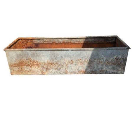 A galvanised drinking trough 155cm x 48cm wide