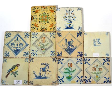 A Matched Set of Three Delft Tiles, 17th century, painted in blue, green and ochre with stylised tulips, 12.5cm wide; A Simil