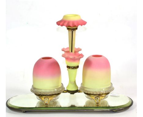 An S Clarke Burmese and Clear Glass Fairy Light, circa 1890, as three spill vases flanked by two candle holders in a plated f