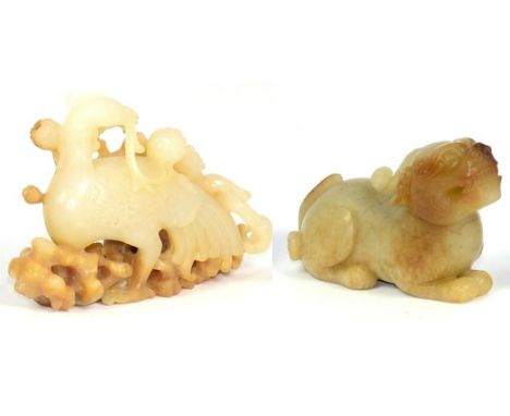 A Carved Jade Figure of a Phoenix, holding a fruiting branch, 8.5cm; and A Similar Lion Dog, 8cm (2)