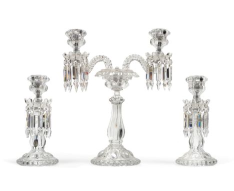 A Baccarat Glass Three Piece Garniture, 20th century, with lobed sconces hung with prismatic drops on lobed baluster stems an