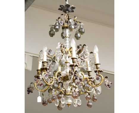 A Gilt Metal and Glass Eight-Light Electrolier, early 20th century, with scroll branches hung with glass drops and with glass